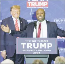  ?? — AFP photo ?? Scott, with Trump behind him, speaks during a campaign event in Concord, New Hampshire. Scott has expressed no interest in becoming a running mate to any of the remaining candidates after he withdrew from the race on Nov 12.