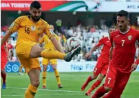  ?? — AP ?? Australia’s defender Aziz Behich (left) in action against Jordan in their first game.