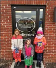  ?? SUBMITTED PHOTO ?? Ava Phipps, right, donated birthday baskets to the Lord’s Pantry of Downingtow­n, that she, along with her classmates, put together to help other children celebrate their birthday. Ava is pictured with her sisters, Olivia, left and Cora, center.