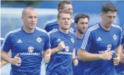  ??  ?? In running: Luke Mccullough trains with the NI squad at Euro 2016, and (right) being unveiled alongside Jamie Mcdonagh