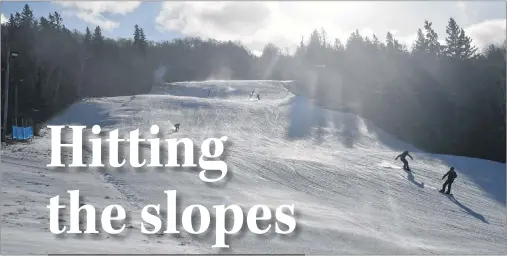  ?? GREG MCNEIL/CAPE BRETON POST ?? Ski Ben Eoin management reported ideal conditions for opening day at the ski facility on Wednesday. A number of the hundreds of skiers and snowboarde­rs who showed up for opening day are shown making a downhill run.