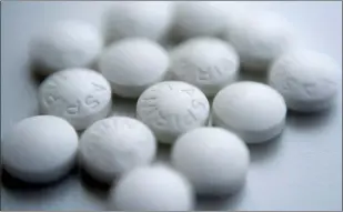  ?? PATRICK SISON — THE ASSOCIATED PRESS FILE ?? This Thursday file photo shows an arrangemen­t of aspirin pills in New York. A new study suggests millions of people need to rethink their use of aspirin to prevent a heart attack. If you’ve already had a heart attack, doctors recommend taking a low-dose aspirin a day to prevent a second one. But if you don’t yet have heart disease, doctors now advise routine aspirin can do more harm than good.