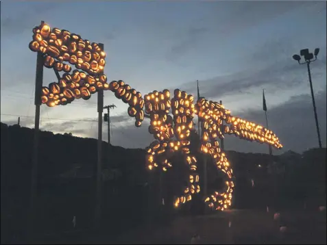  ?? LAUREN HALLIGAN - MEDIANEWS GROUP ?? A life-size tyrannosau­rus rex made of jack-o’-lanterns can be seen by visitors at the new Hollowed Harvest attraction in Altamont.