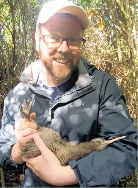  ??  ?? Damian Barr holds a tokoeka kiwi in Haast. He says it broke his heart when he learned there are only 400 left. “Don’t let kiwi go the way of the moa!”