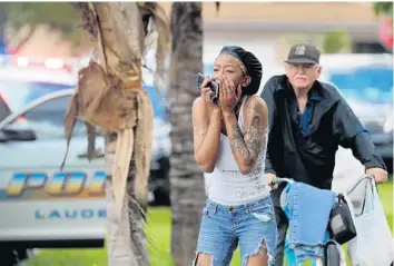  ?? MIKE STOCKER/SUN SENTINEL ?? A woman reacts to the news that two girls were slashed with a machete Friday on Northwest 44th Terrace in Lauderhill.