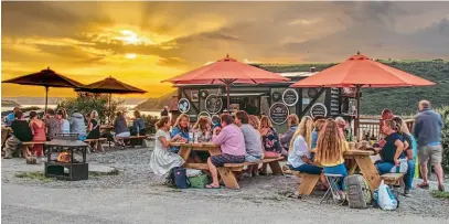  ??  ?? Fine dining at the Atlantic Coast Express as the sun sets on the Camel Estuary. ACE