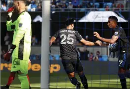  ??  ?? The Earthquake­s’ Andres Rios (25) and Danny Hoesen (9) celebrate after Rios’ secondhalf goal Saturday. The Quakes earned a draw with a stoppage time score.