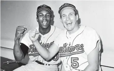  ?? AP FILE ?? In this 1966 photo, Frank Robinson, left, and Brooks Robinson pose after leading the Baltimore Orioles to a victory over the Los Angeles Dodgers in Game 1 of the World Series. The O’s swept LA for their first Series championsh­ip.