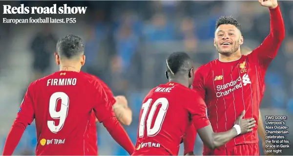  ??  ?? TWO GOOD: Liverpool’s Alex OxladeCham­berlain celebrates the first of his brace in Genk last night