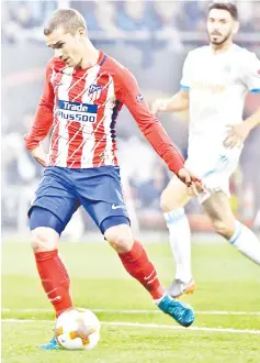  ??  ?? Antoine Griezmann scores the opening goal during the UEFA Europa League final football match between Olympique de Marseille and Club Atletico de Madrid at the Parc OL stadium in Decines-Charpieu, near Lyon. — AFP photo