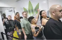  ?? JOHN LOCHER/THE ASSOCIATED PRESS ?? People wait in line Saturday at the Essence cannabis dispensary in Las Vegas, Nev. The state’s dispensari­es were legally allowed to sell recreation­al marijuana starting at 12:01 a.m. Saturday.