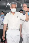  ??  ?? STILL AT THE HELM: Prime Minister Lee Hsien Loong arrives at a People’s Action Party branch office yesterday.