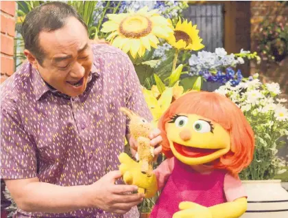  ?? Picture / AP ?? Sesame Street locals including Alan Muraoka helped to quickly introduce Julia and explain her autism.