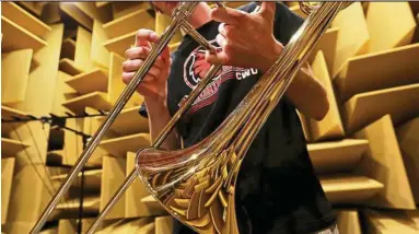  ??  ?? The chamber’s sound-absorbing wedges are reflected in the trombone.