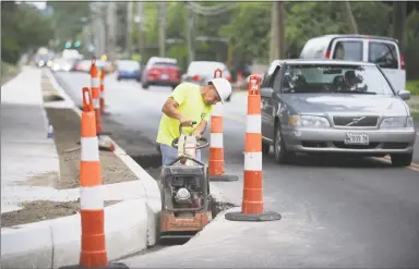  ?? Michael Cummo / Hearst Connecticu­t Media ?? Connecticu­t Department of Transporta­tion employees work on widening Courtland Avenue in Stamford.