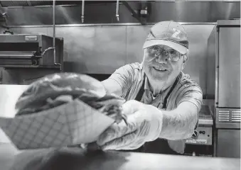  ?? Tom Reel / Staff photograph­er ?? John Godoy works in the kitchen at the San Antonio Zoo’s Beastro restaurant.