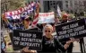  ?? PHOTO: AFP ?? Pro-Trump and anti-Trump demonstrat­ors hold up signs outside the Manhattan Criminal Court in New York City as former US president Donald Trump attends the first day of his trial for allegedly covering up hush money payments linked to extramarit­al affairs on Monday.