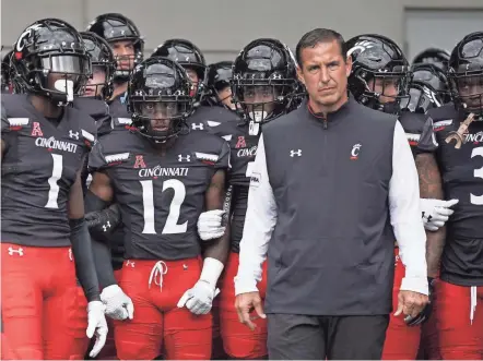  ?? SAM GREENE/THE CINCINNATI ENQUIRER JEFF DEAN/AP ?? ABOVE: The Cincinnati Bearcats are 31-6 over the previous three seasons under head coach Luke Fickell. BELOW: Bearcats quarterbac­k Desmond Ridder has completed 54 of his 83 passes for 748 yards and seven touchdowns. The senior has thrown two intercepti­ons.