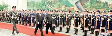  ?? — Reuters photo ?? Xi (front, centre) holds a welcoming ceremony for Kim before their talks at the Great Hall of the People in Beijing, China, in this photo released by North Korea’s Korean Central News Agency (KCNA).