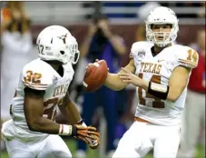  ??  ?? Texas quarterbac­k David Ash looks to pass to Johnathan Gray during the first quarter of the Alamo Bowl against Oregon State on Saturday in San Antonio. the longhorns won, 31-27.