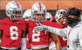  ?? AP ?? Ohio State receiver Chris Olave (2) surprised many with his decision to put the NFL on hold, but he says he wants to improve his game while helping the Buckeyes win a title.