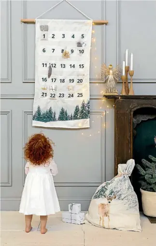  ?? DOWN TO THE WOODS / TEA PEA HOME ?? Woodland animals and green foliage create a whimsical Christmas look. Down to the Woods’ advent calendar $95 from teapea.co.nz.