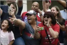  ?? THE ASSOCIATED PRESS ?? Fans celebrate Red Sox manager Alex Cora’s arrival to his hometown with the 2018 World Series trophy in Caguas, Puerto Rico on Saturday.