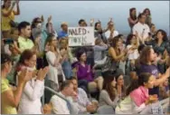  ?? THE ASSOCIATED PRESS ?? Demonstrat­ors cheer Wednesday at a city commission meeting in Miami Beach, Fla. Opponents want to stop the aerial spraying of the insecticid­e naled, used to combat the Aedes aegypti mosquito.