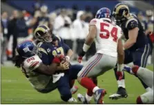  ?? MATT DUNHAM — THE ASSOCIATED PRESS ?? New York Giants defensive tackle Damon Harrison (98) tackles Los Angeles Rams quarterbac­k Case Keenum (17) during an NFL football game between New York Giants and Los Angeles Rams at Twickenham stadium in London, Sunday.