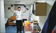  ?? WANG ZHUANGFEI / CHINA DAILY ?? Li Heng exercises in his cabin.