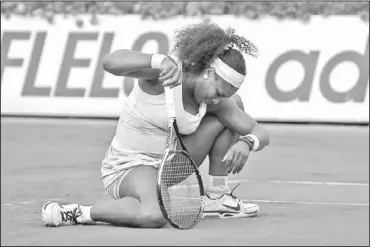  ??  ?? Serena Williams reacts Tuesday during her loss to France’s Virginie Razzano in the first round of the French Open tennis tournament in Paris. Her sister Venus lost the next day.