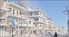  ??  ?? Smoke billows from a building following a reported bombardmen­t by pro-Syrian government forces in the town of Maaret al-Numan in Syria’s Idlib province. — AFP photo