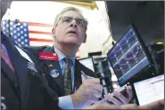  ?? AP/RICHARD DREW ?? Trader Richard Deviccaro works on the floor of the New York Stock Exchange on Friday.