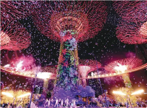  ?? — AFP ?? on Saturday. Bubbles, flames and light projection­s are seen around the landmark Supertrees to mark the Gardens by the Bay’s fifth anniversar­y celebratio­ns in Singapore