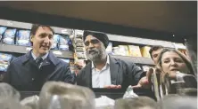  ?? ETHAN CAIRNS/THE CANADIAN PRESS ?? Prime Minister Justin Trudeau, Vancouver South MP Harjit Sajjan and Finance Minister Chrystia Freeland visit the Punjab Food Center in Vancouver on Wednesday.