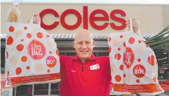  ?? Picture: GLENN HAMPSON ?? Coles State Manager Jerry Farrell uses new bags the company is selling at its Hope Island store for his shopping, which includes a baguette smothered in plastic wrapping. Below: Fruit and veg in plastic packaging at a Woolworths supermarke­t.