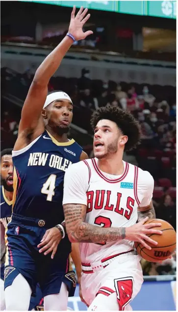  ?? NAM Y. HUH/AP ?? Bulls guard Lonzo Ball, driving against Pelicans guard Devonte’ Graham in the first half Friday, had 19 points and shot 7-for-9 from the field, including 5-for-6 from three-point range.