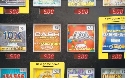  ?? ALEX DRIEHAUS/THE VIRGINIAN-PILOT ?? Virginia Lottery tickets sit in a vending machine in a Norfolk store. Experts have raised questions about some of the state’s frequent lottery winners.
