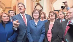  ?? J. SCOTT APPLEWHITE/AP ?? After a procedural vote aimed at reopening the government, lawmakers praise Sen. Susan Collins, R-Maine, on Monday for leading a bipartisan effort to get a spending measure passed.