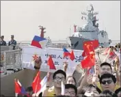  ?? Bullit Marquez Associated Press ?? STUDENTS CHEER the arrival of a Chinese military ship, background, at a Manila port in 2019.