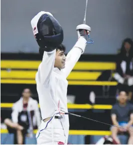  ??  ?? TWO-time MVP Sammuel Tranquilan raises his hands in jubilation after leading UE to victories in two team events on Thursday.