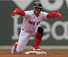  ?? MATT sTONE pHOTOs / HErAld sTAff filE; BElOw, NANcy lANE / HErAld sTAff filE ?? UPS AND DOWNS: Christian Arroyo celebrates on second after his RBI double against the Tampa Bay Rays at Fenway Park on April 7. At left, Sox third baseman Rafael Devers tries to barehand a grounder on Opening Day. Below, pitcher Garrett Richards talks with catcher Christian Vazquez on April 4.