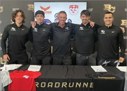  ?? JUSTIN COUCHOT — ENTERPRISE-RECORD ?? Butte College men's soccer players Pontus Schmitz Gustafsson, left, Noris Iten, second from left, Louis Hester, second from right, and Bilal Tanriverdi, right, stand together with head coach Ross Sandberg, center, at the final Roadrunner­s' signing day on Wednesday.