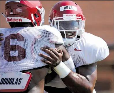  ?? NWA Democrat-Gazette/ANDY SHUPE ?? Arkansas senior defensive end Jamario Bell (right) goes through a drill with senior Gabe Richardson during practice Tuesday. Bell, Richardson and fellow senior Dorian Gerald are the only defensive ends on the Razorbacks’ roster who are not true freshmen.