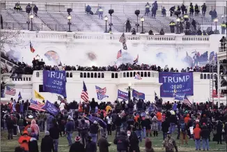  ?? John Minchillo / Associated Press ?? People storm the Capitol in Washington on Jan. 6. An internal report by the U.S. Capitol Police describes a multitude of missteps that left the force unprepared for the Jan. 6 insurrecti­on.