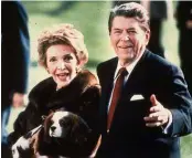 ??  ?? The Reagans with their dog Rex pause for photograph­s while strolling on the White House South lawn.