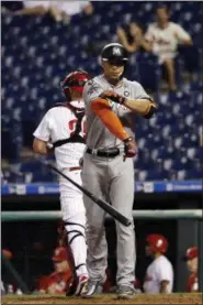  ?? MATT SLOCUM — THE ASSOCIATED PRESS ?? Miami Marlins’ Giancarlo Stanton throws his bat after striking out against Philadelph­ia Phillies relief pitcher Luis Garcia during the 13th inning of a baseball game, Sept. 12 in Philadelph­ia. Philadelph­ia won 9- 8in 15innings.
