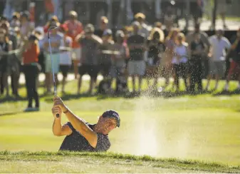  ?? Eric Risberg / Associated Press ?? Phil Mickelson follows his shot out of the bunker on No. 17 during the final round of the Safeway Open at Silverado Resort in Napa. Mickelson finished three strokes behind.