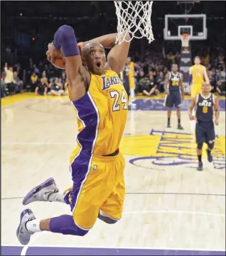  ?? Associated Press ?? GONE — Los Angeles Lakers guard Kobe Bryant goes up for a dunk during the first half of an NBA basketball game against the Utah Jazz in Los Angeles in this 2013 file photo. Bryant is the game’s fourth-leading scorer. He spent 20 years with the Los Angeles Lakers, 18 as an All-Star, and won five titles. Then came the helicopter crash in the fog-shrouded California hills that reverberat­ed across sports and across continents.