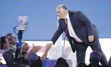  ?? LM Otero Associated Press ?? HUNGARIAN Prime Minister Viktor Orban greets the crowd in Dallas after speaking at the Conservati­ve Political Action Conference. He attacked the media, liberals, immigrants and LGBTQ people in his speech.